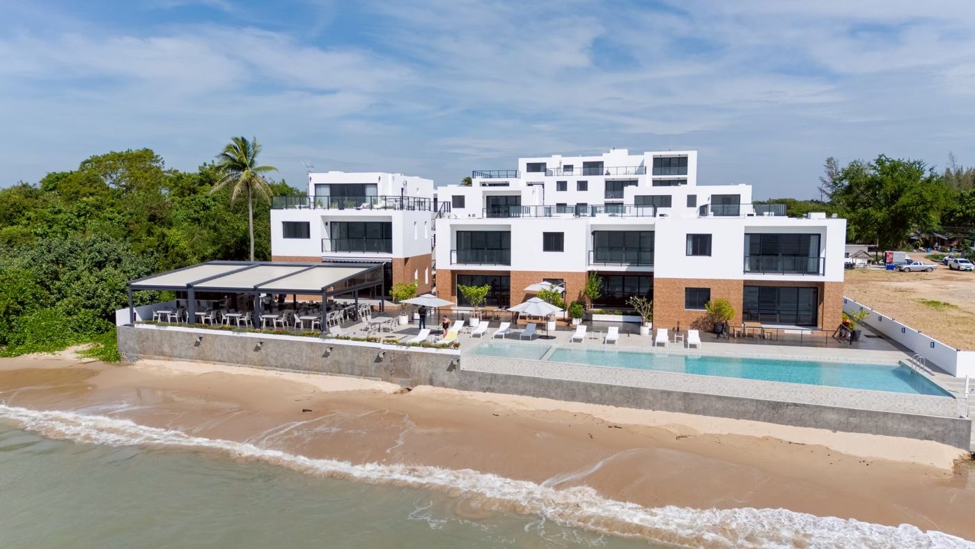 Aerial view of The Village with the pool and beach in front